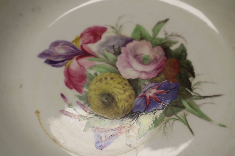 A Chelsea Derby teabowl and saucer painted in the style of Edward Withers with flowers under a blue border and a pair of soup plates
